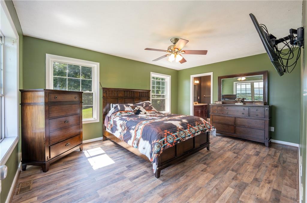 387 George Lane Seward, PA 15954 - Photo 17 of 45 a bedroom with a large bed a chandelier and dresser