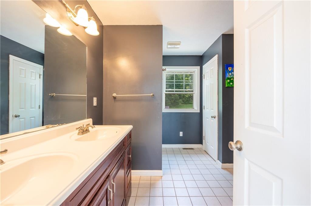 387 George Lane Seward, PA 15954 - Photo 19 of 45 a spacious bathroom with a granite countertop sink a mirror and a bathtub