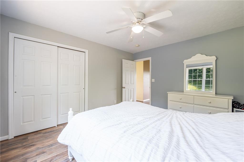 387 George Lane Seward, PA 15954 - Photo 27 of 45 a spacious bedroom with a large bed and a chandelier