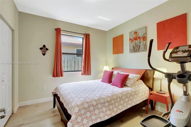 a bedroom with a bed and painting on the wall