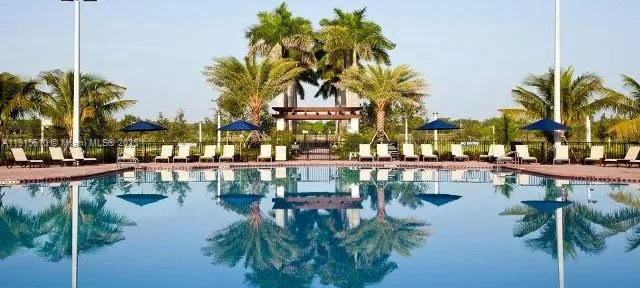 a front view of house with yard and swimming pool