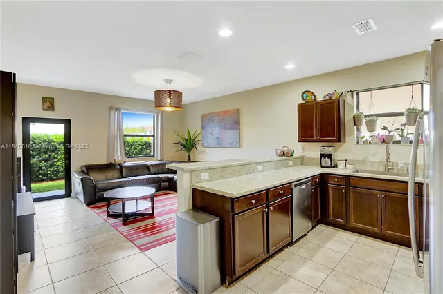 a kitchen with a stove sink and cabinets