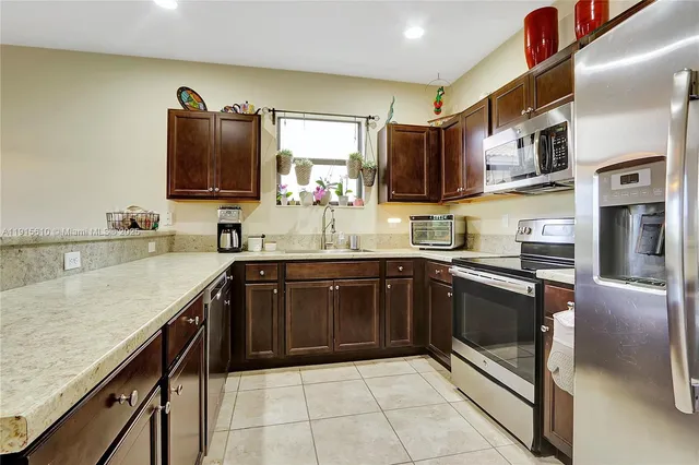 a kitchen with stainless steel appliances granite countertop a sink stove and oven