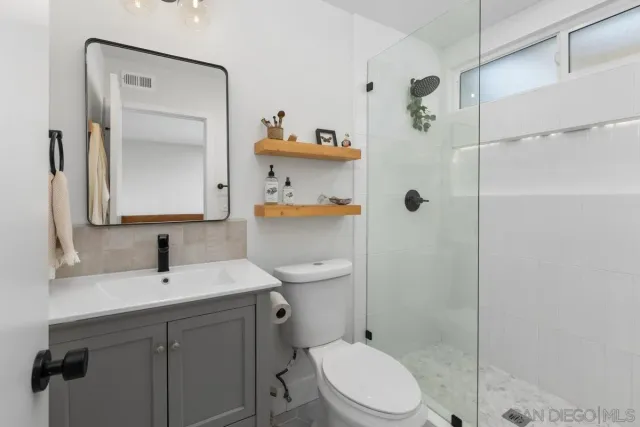 a bathroom with a sink toilet and shower