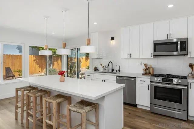 a kitchen with appliances a sink and cabinets