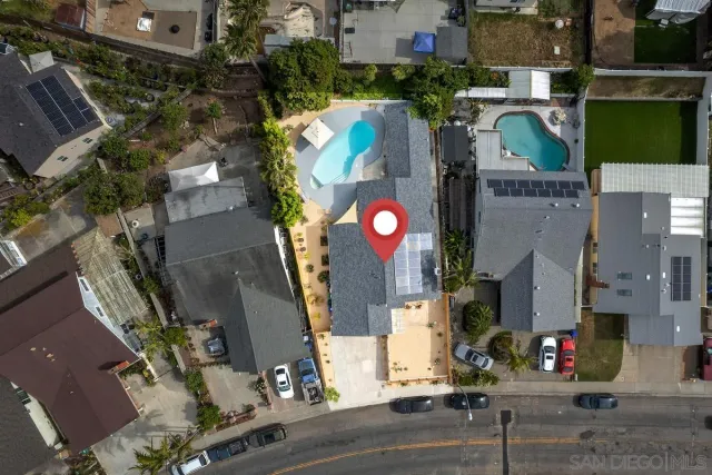 an aerial view of houses with street
