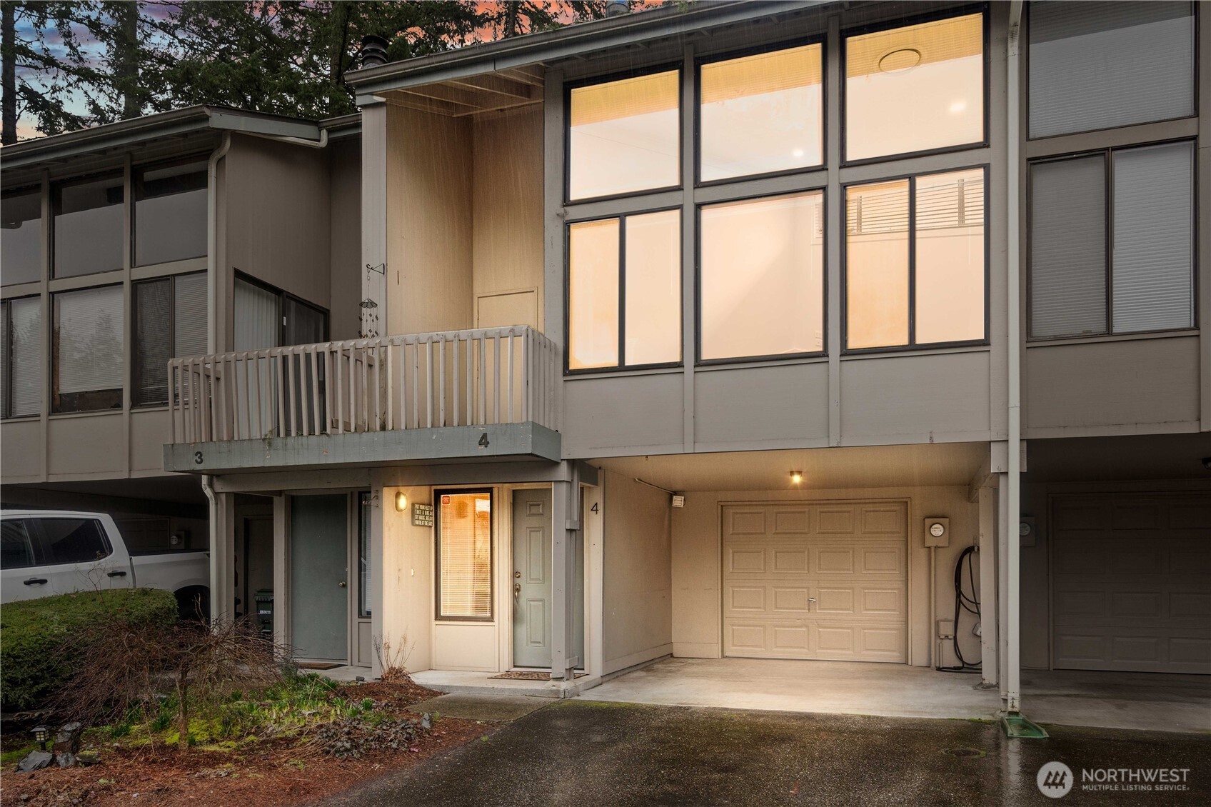 17303 Spanaway Loop Road South, Unit 4 Spanaway, WA 98387 - Photo 1 of 33 a front view of a house with a yard and garage