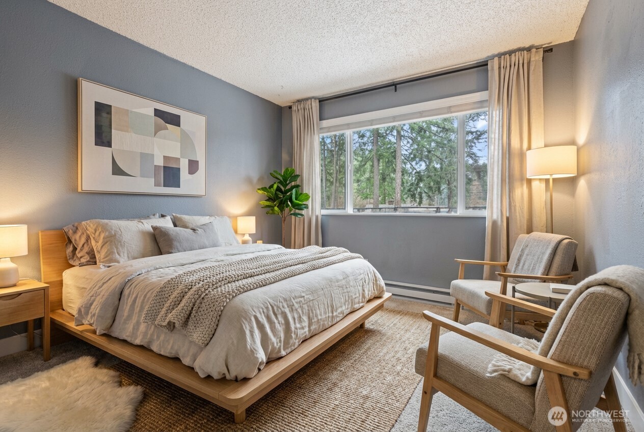 17303 Spanaway Loop Road South, Unit 4 Spanaway, WA 98387 - Photo 15 of 33 a bedroom with a bed and chair