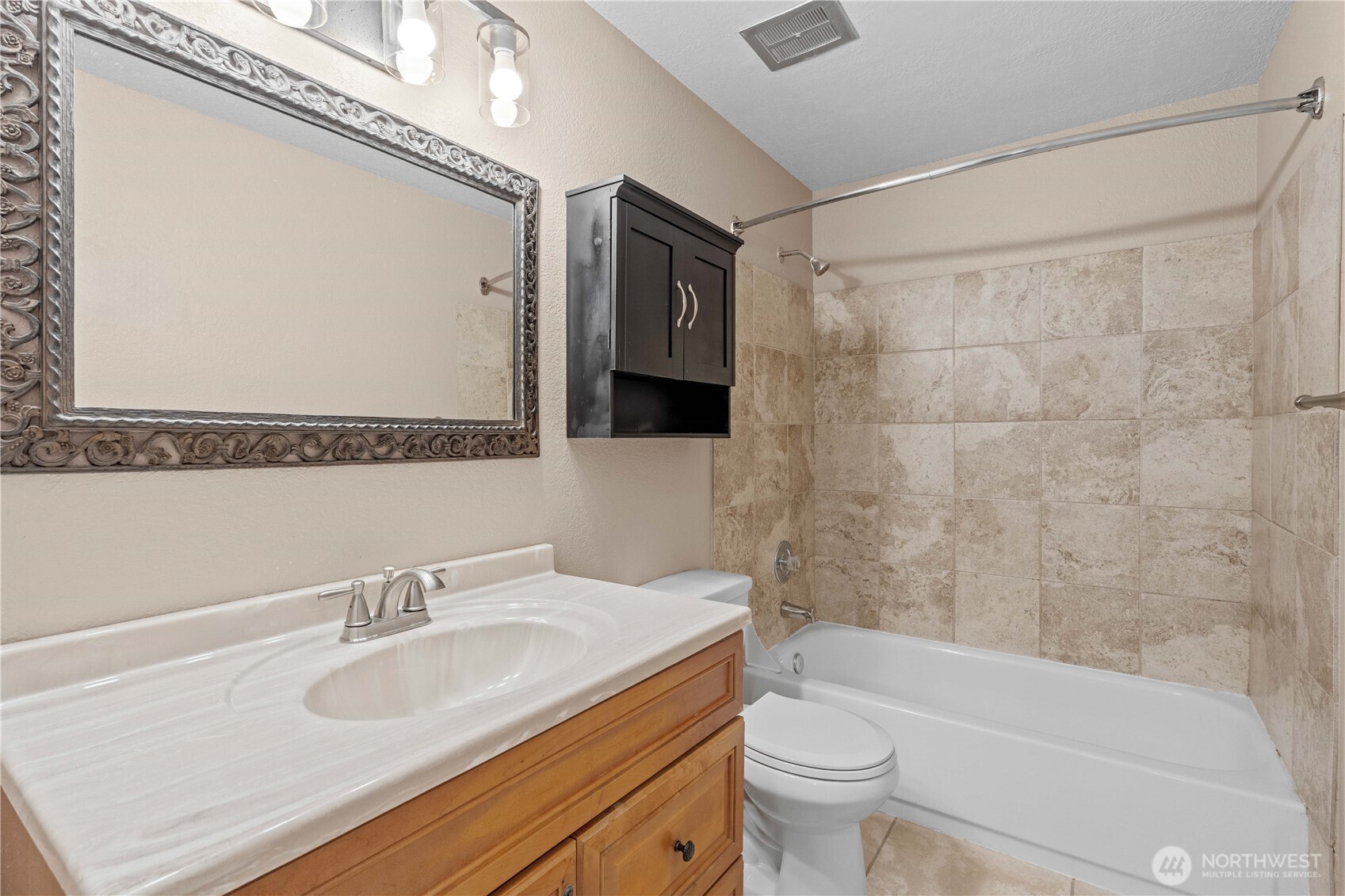 17303 Spanaway Loop Road South, Unit 4 Spanaway, WA 98387 - Photo 17 of 33 a bathroom with a sink toilet vanity and shower
