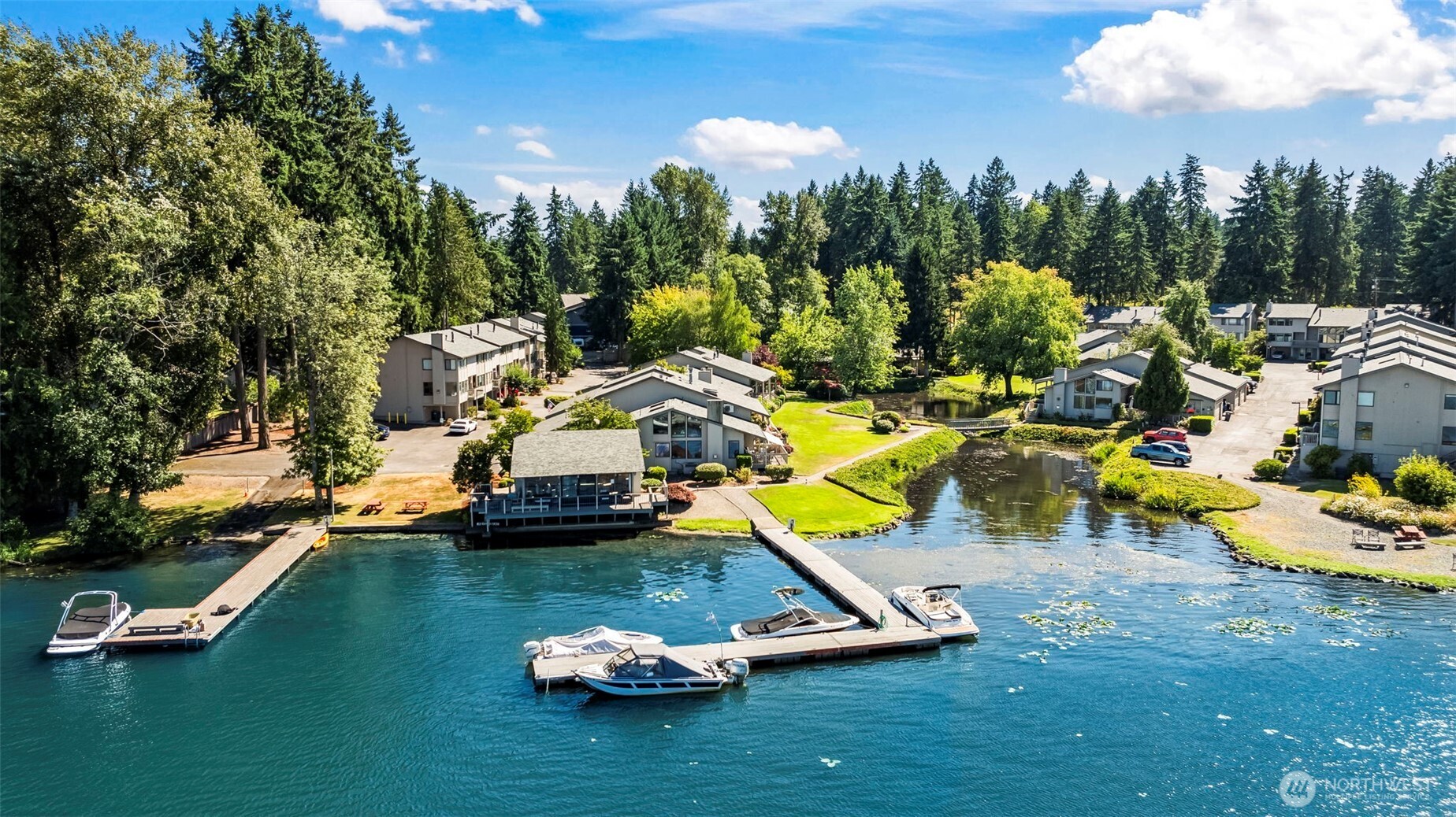 17303 Spanaway Loop Road South, Unit 4 Spanaway, WA 98387 - Photo 2 of 33 a view of a lake with lawn chairs
