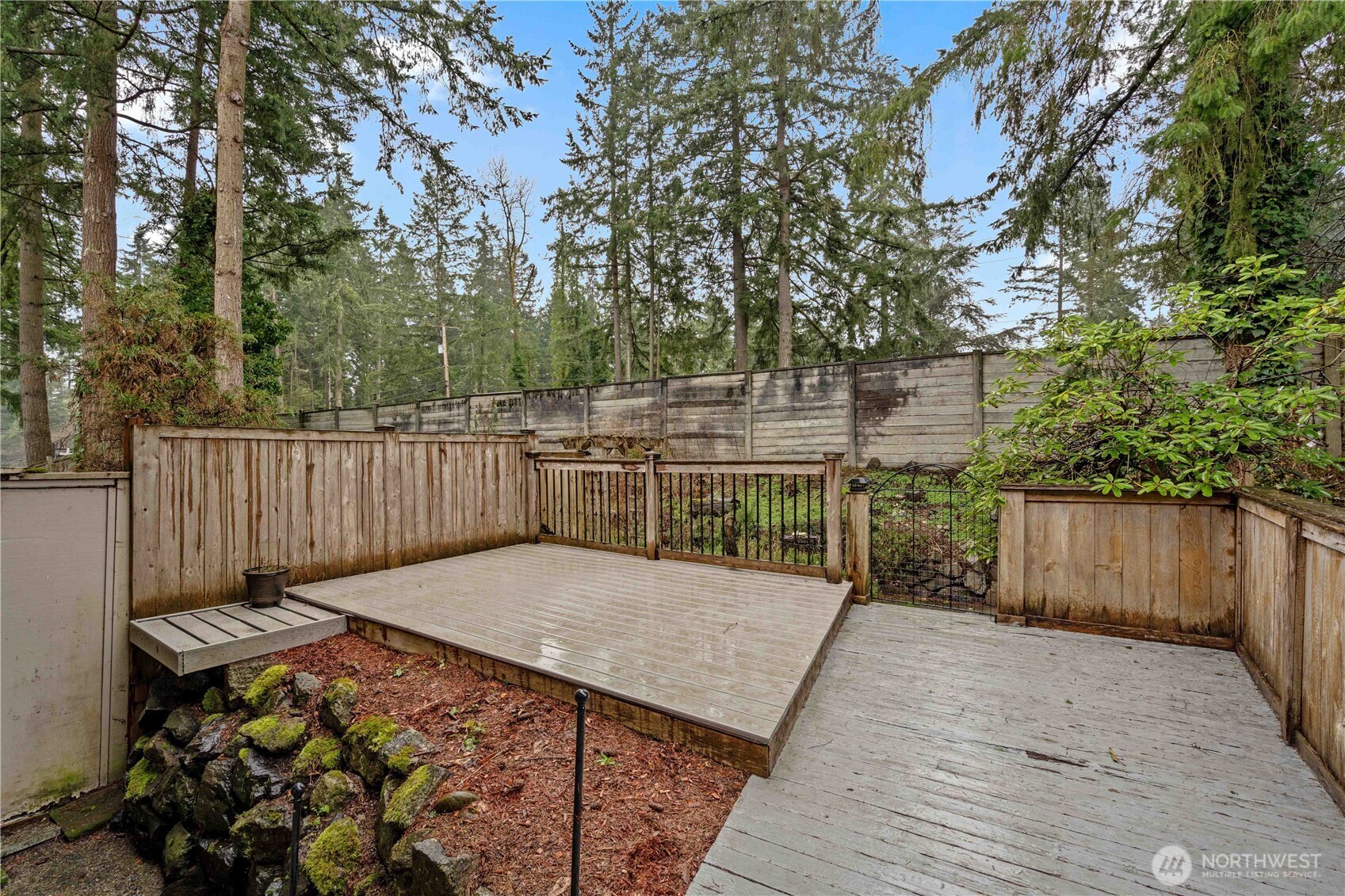 17303 Spanaway Loop Road South, Unit 4 Spanaway, WA 98387 - Photo 26 of 33 a view of a backyard with wooden fence
