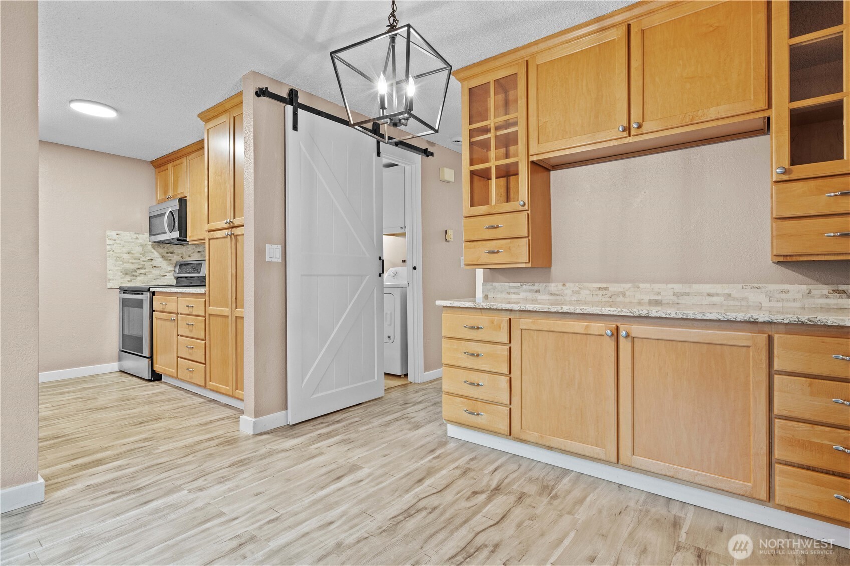 17303 Spanaway Loop Road South, Unit 4 Spanaway, WA 98387 - Photo 6 of 33 a kitchen with stainless steel appliances granite countertop a refrigerator and a stove top oven