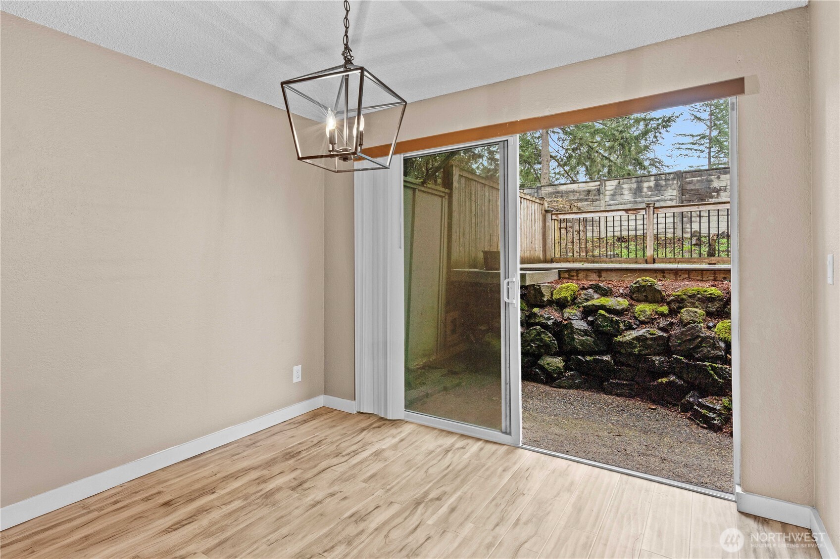 17303 Spanaway Loop Road South, Unit 4 Spanaway, WA 98387 - Photo 7 of 33 a view of a room with wooden floor and a window