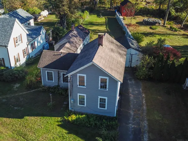 a aerial view of a house with a yard and lake view