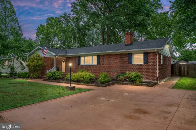 a front view of a house with a yard and a garage
