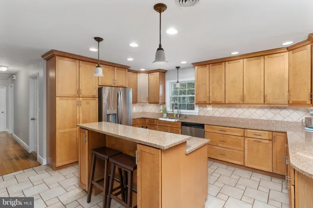a kitchen that has a sink a stove and a window