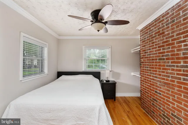 a view of a room with wooden floor and entryway