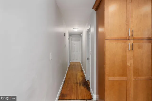 a view of an empty room and wooden floor