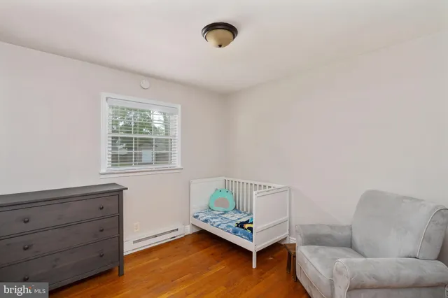 a view of a room with wooden floor and a ceiling fan