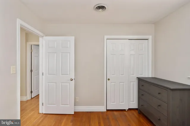 a bedroom with a bed chandelier and a window