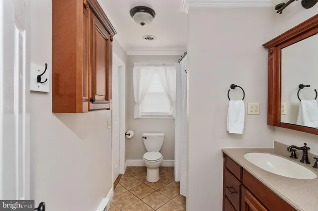 a front view of a house with a yard and green space