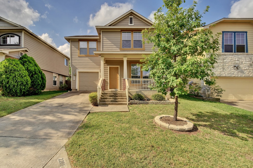 2201 Keepsake Drive Austin, TX 78745 - Photo 1 of 25 a front view of a house with garden