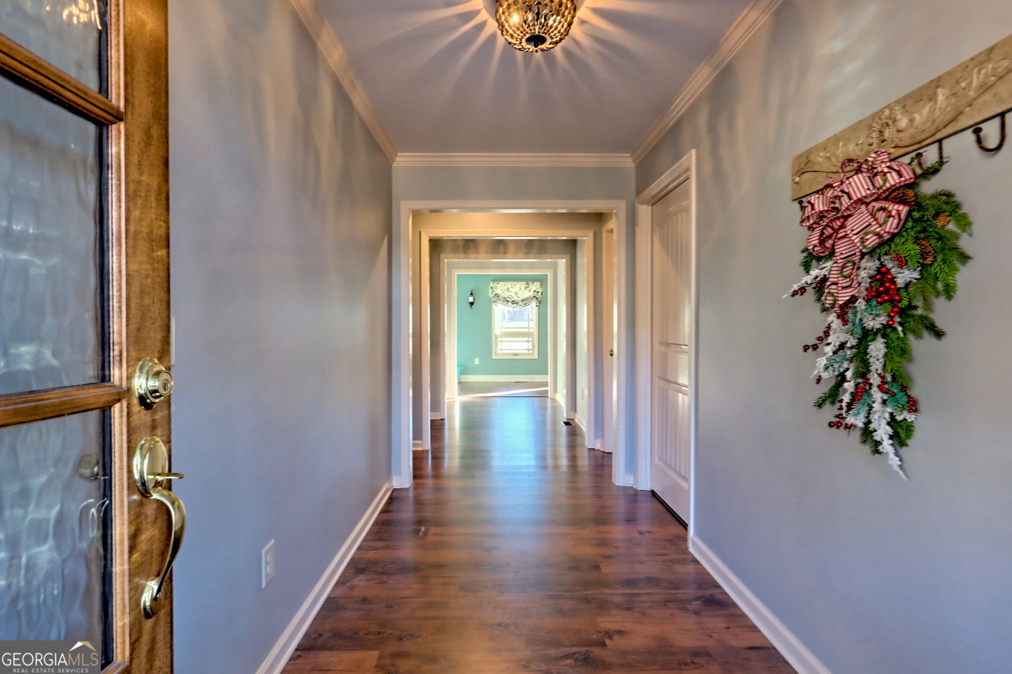 784 Wolffork Church Road Rabun Gap, GA 30568 - Photo 11 of 31 a view of a hallway with wooden floor and table and a potted plant