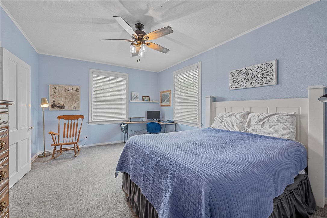 702 North 15th Street Waco, TX 76707 - Photo 15 of 45 a bedroom with a bed and a chandelier