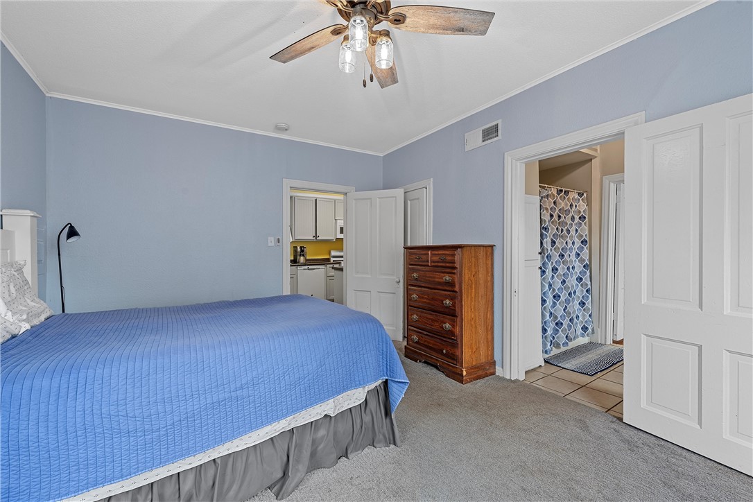 702 North 15th Street Waco, TX 76707 - Photo 16 of 45 a bedroom with a bed and a chandelier