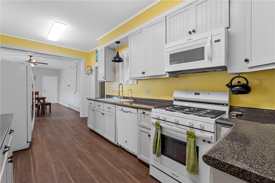 702 North 15th Street Waco, TX 76707 - Photo 20 of 45 a kitchen with stainless steel appliances granite countertop a stove a sink and a microwave