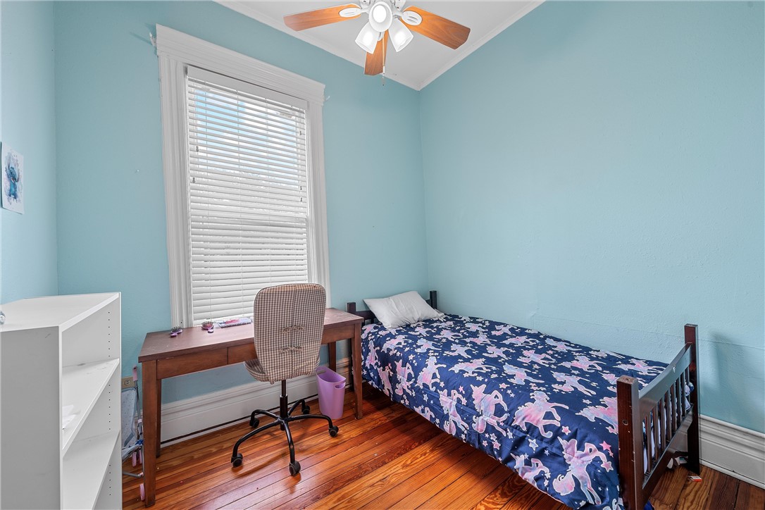 702 North 15th Street Waco, TX 76707 - Photo 23 of 45 a bedroom with a bed and a workspace