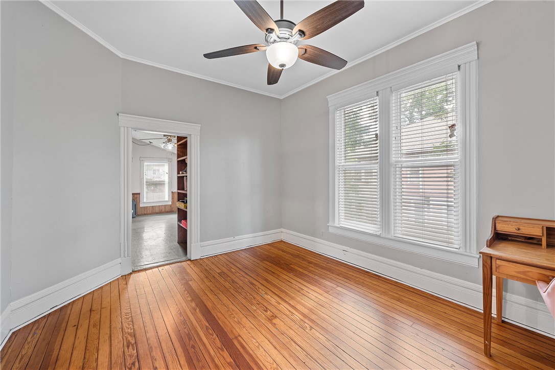 702 North 15th Street Waco, TX 76707 - Photo 27 of 45 a view of empty room with wooden floor and fan