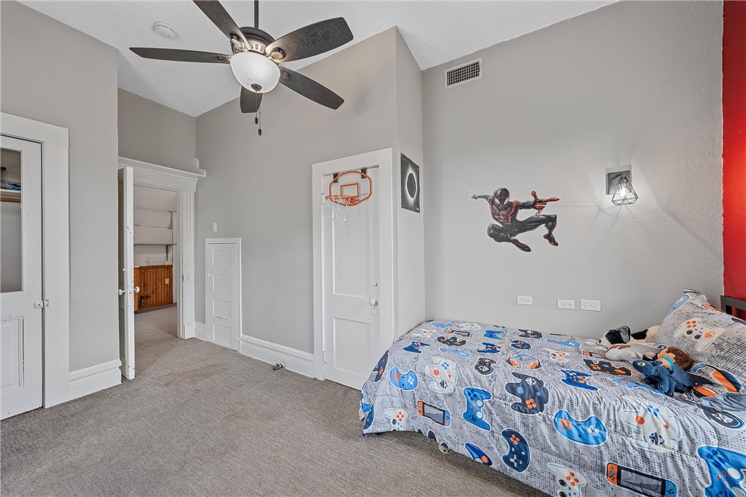 702 North 15th Street Waco, TX 76707 - Photo 31 of 45 a bedroom with a bed and a chandelier