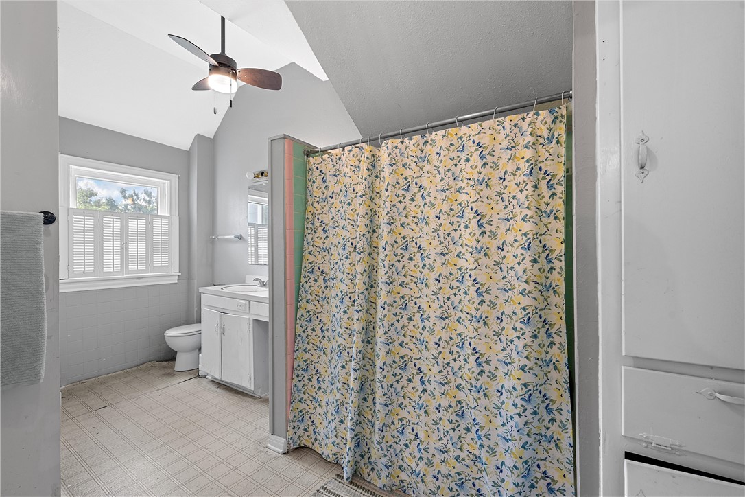 702 North 15th Street Waco, TX 76707 - Photo 33 of 45 a bathroom with a shower curtain and a toilet