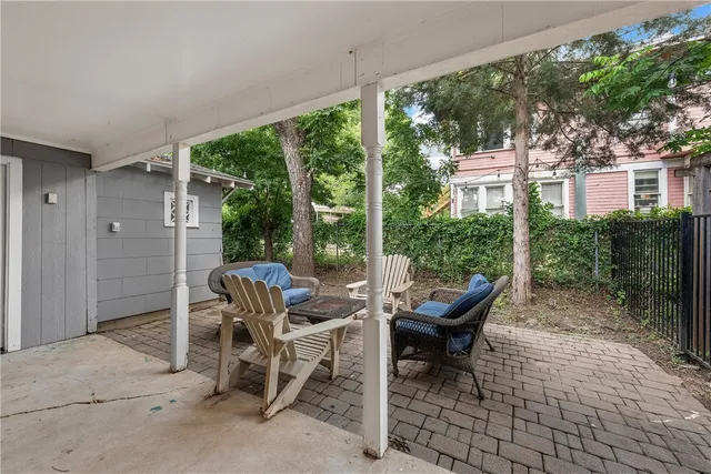 a view of a patio with table and chairs and potted plants