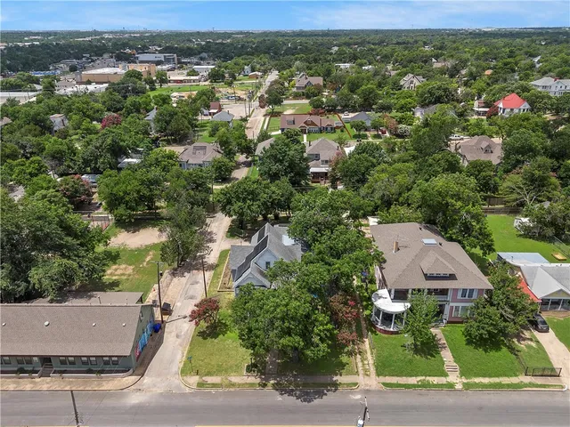 an aerial view of residential houses with city view