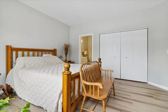 a bedroom with a bed and chair