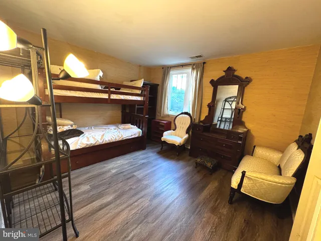 a bedroom with furniture and wooden floor