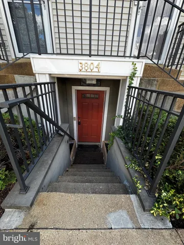 a view of a porch with furniture and floor to ceiling window stairs