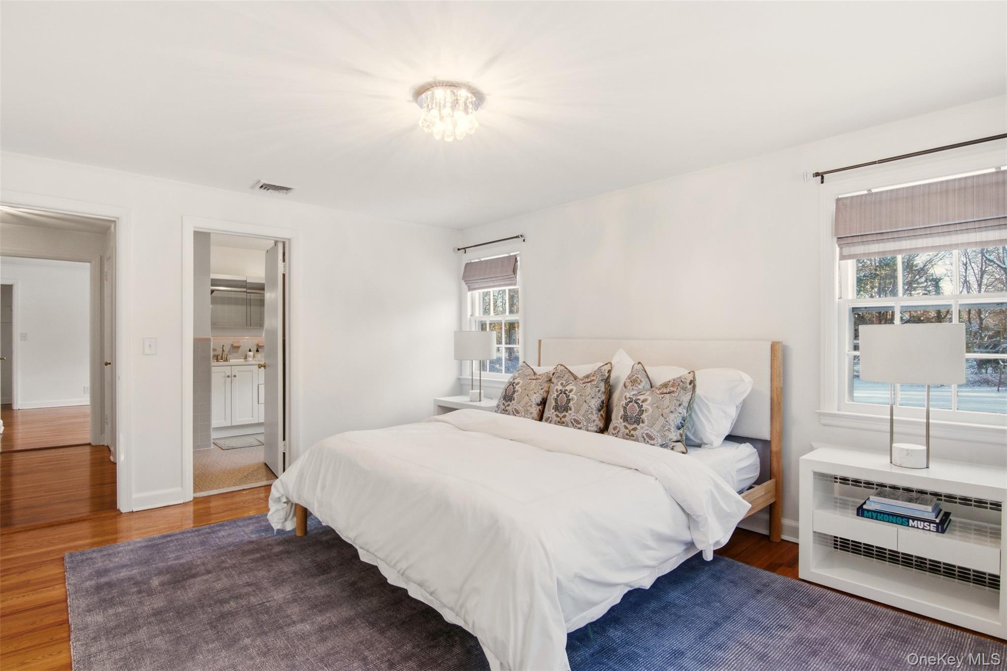 55 White Hill Road Cold Spring Harbor, NY 11724 - Photo 11 of 13 a bedroom with a bed and a view of kitchen