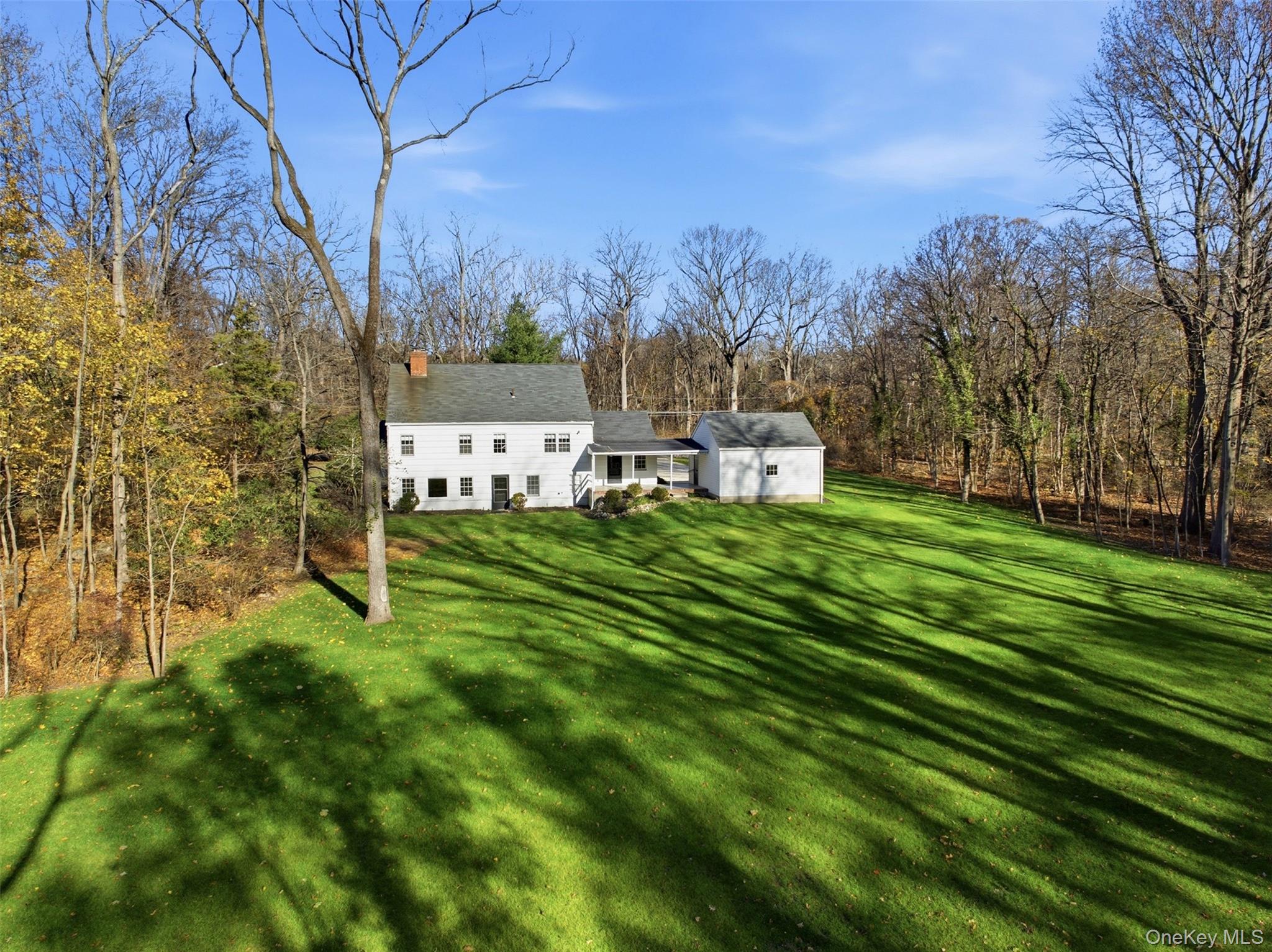 55 White Hill Road Cold Spring Harbor, NY 11724 - Photo 4 of 13 a view of a chairs in a yard with wooden fence