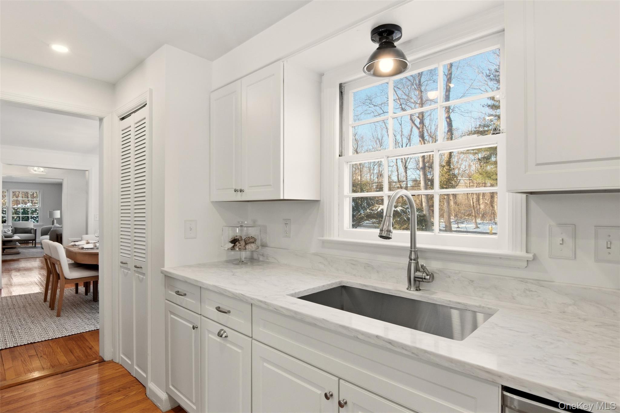 55 White Hill Road Cold Spring Harbor, NY 11724 - Photo 10 of 13 a kitchen with a sink cabinets and window