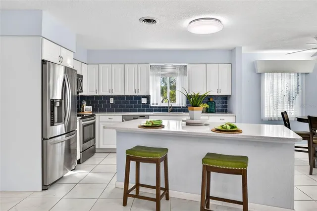 a kitchen with appliances a sink and cabinets