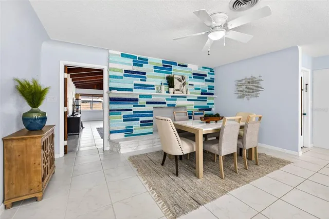 a dining room with furniture and window
