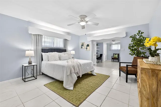 a bed room with a bed and a chandelier