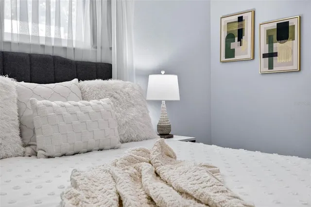 a bedroom with a bed and wall painting