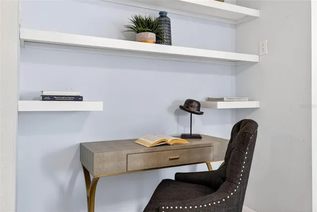 a dining room with furniture and potted plant