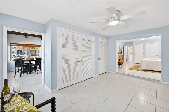 a view of a livingroom with furniture and a chandelier fan