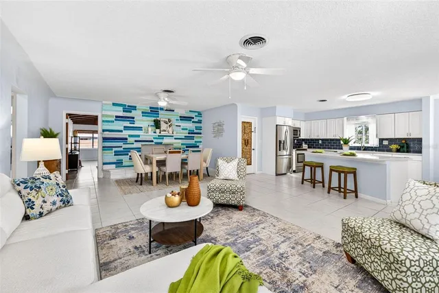 a living room with furniture and kitchen view