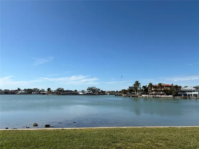 a view of a lake with houses in the back